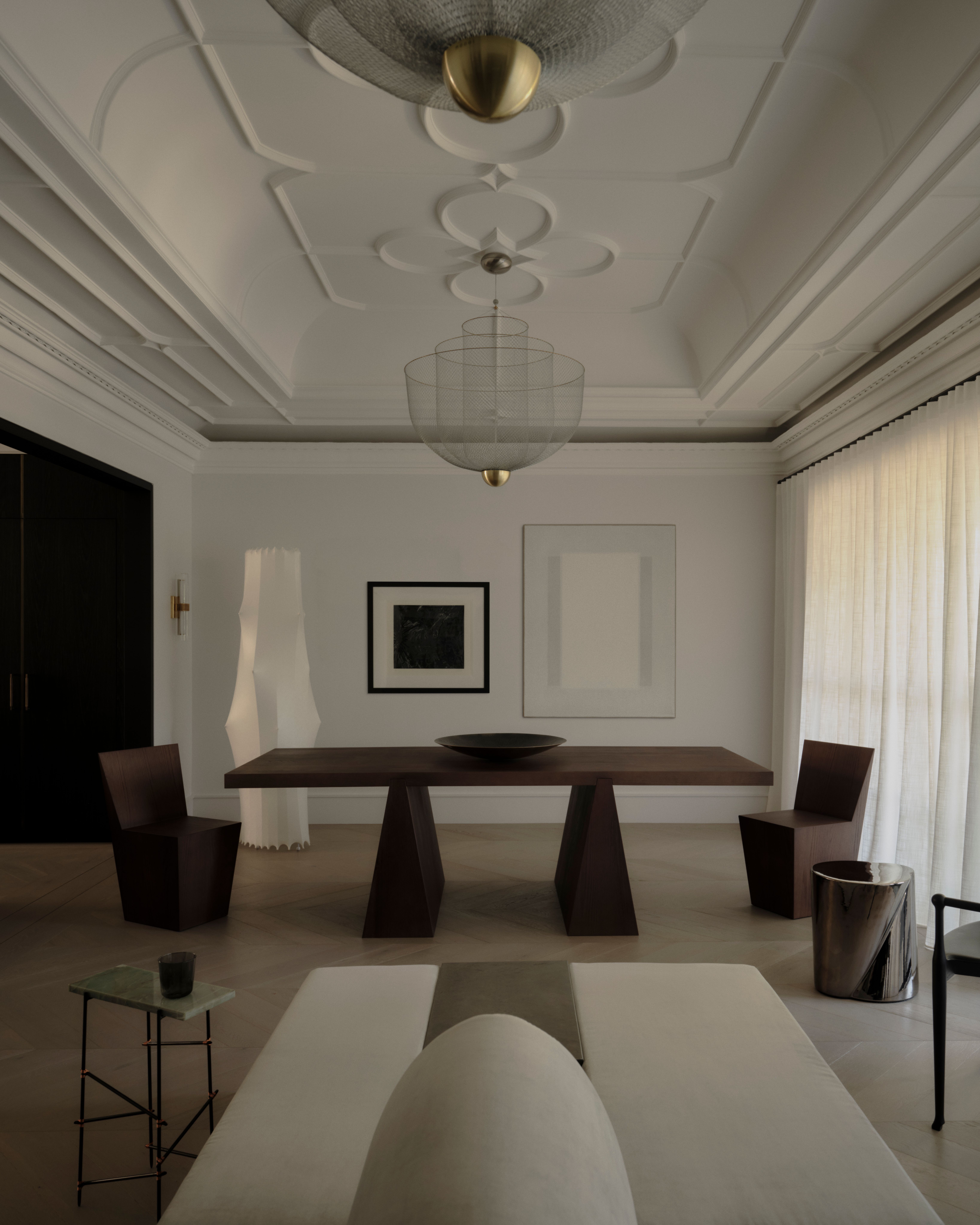 Formal dining room with sculptural pendant and carved timber table in the Vaucluse residence