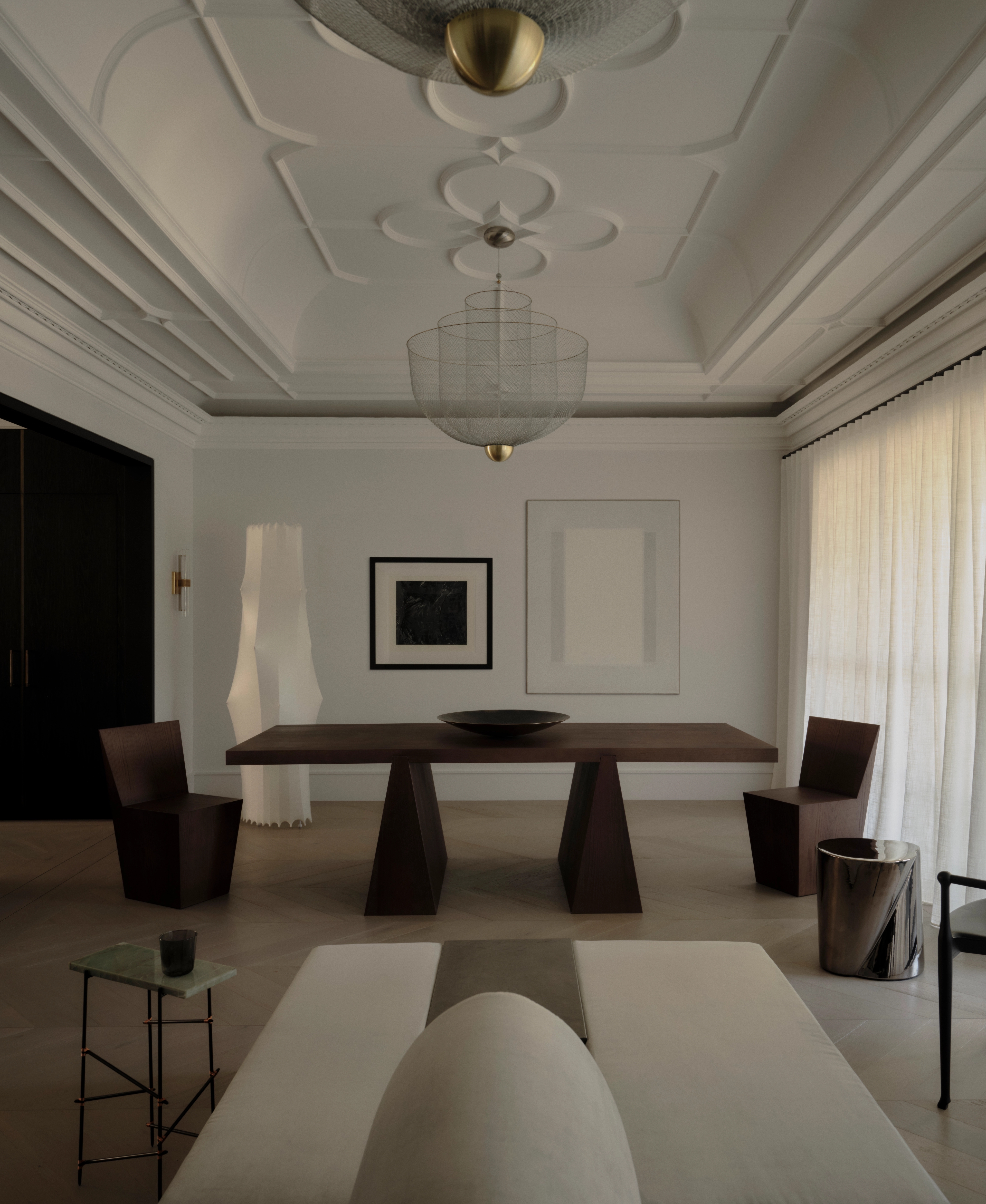 Formal dining room with sculptural pendant and carved timber table in the Vaucluse residence