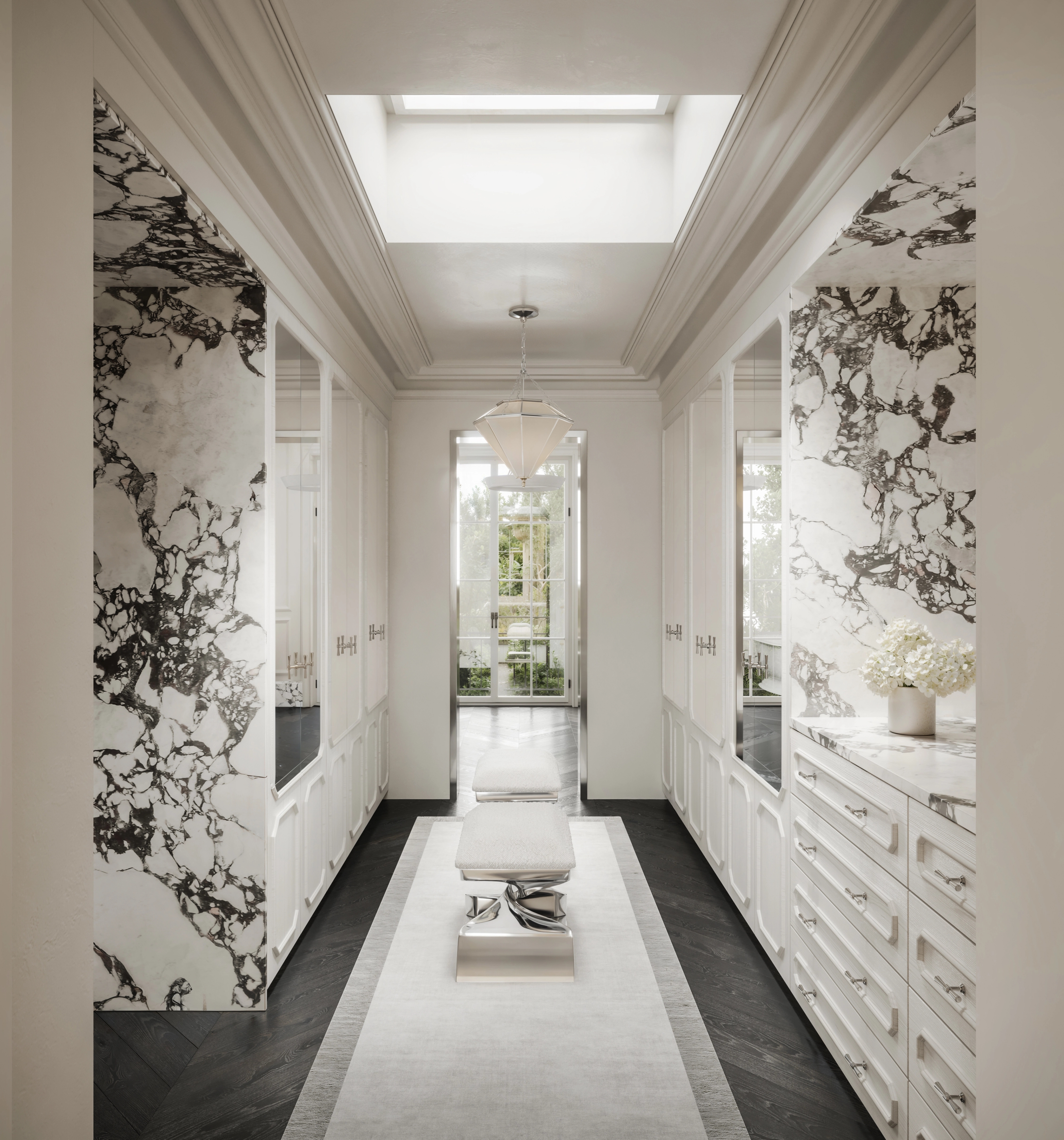 Skylit marble dressing corridor lined with built-in drawers and a pale central runner