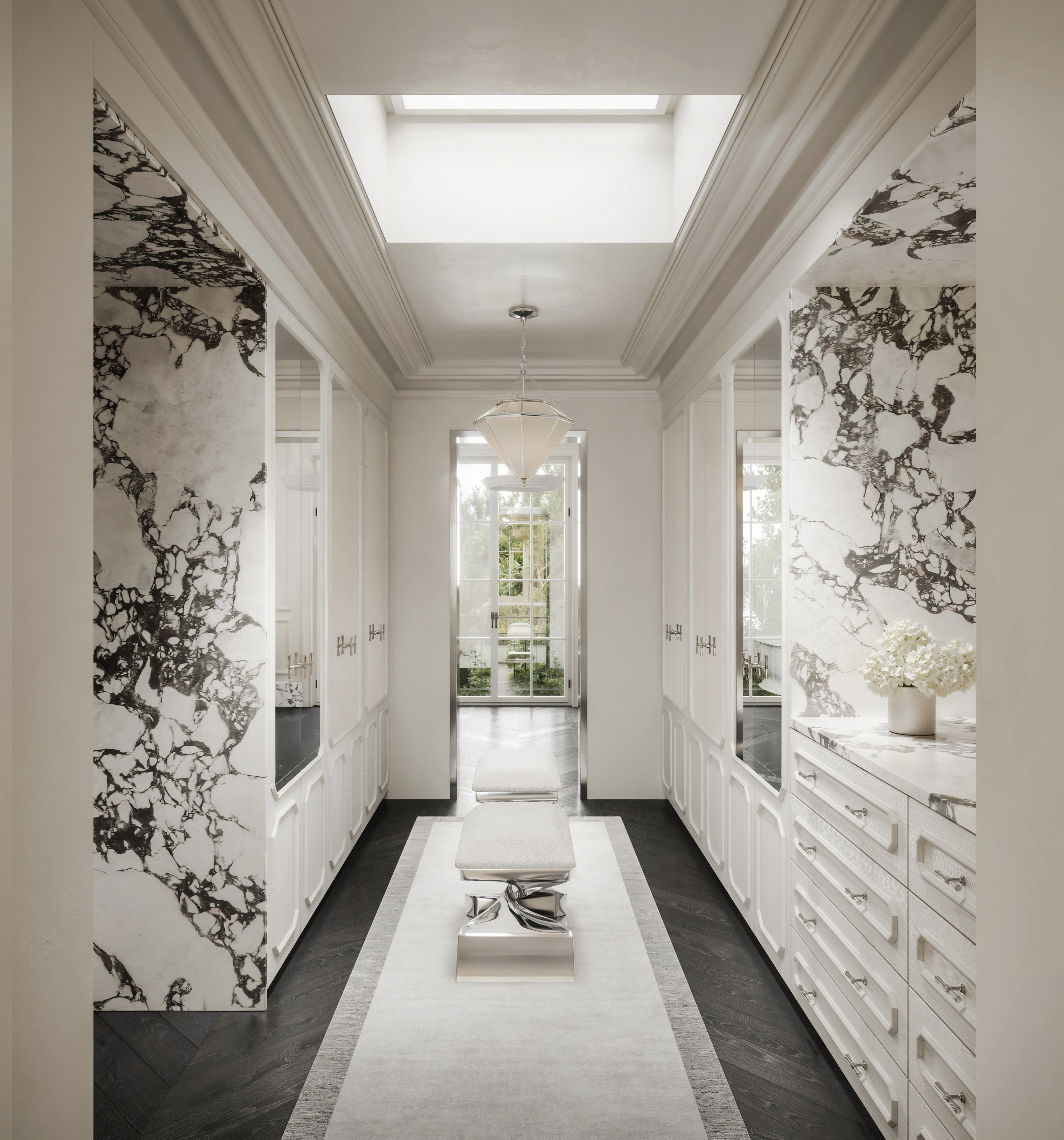 Skylit marble dressing corridor lined with built-in drawers and a pale central runner
