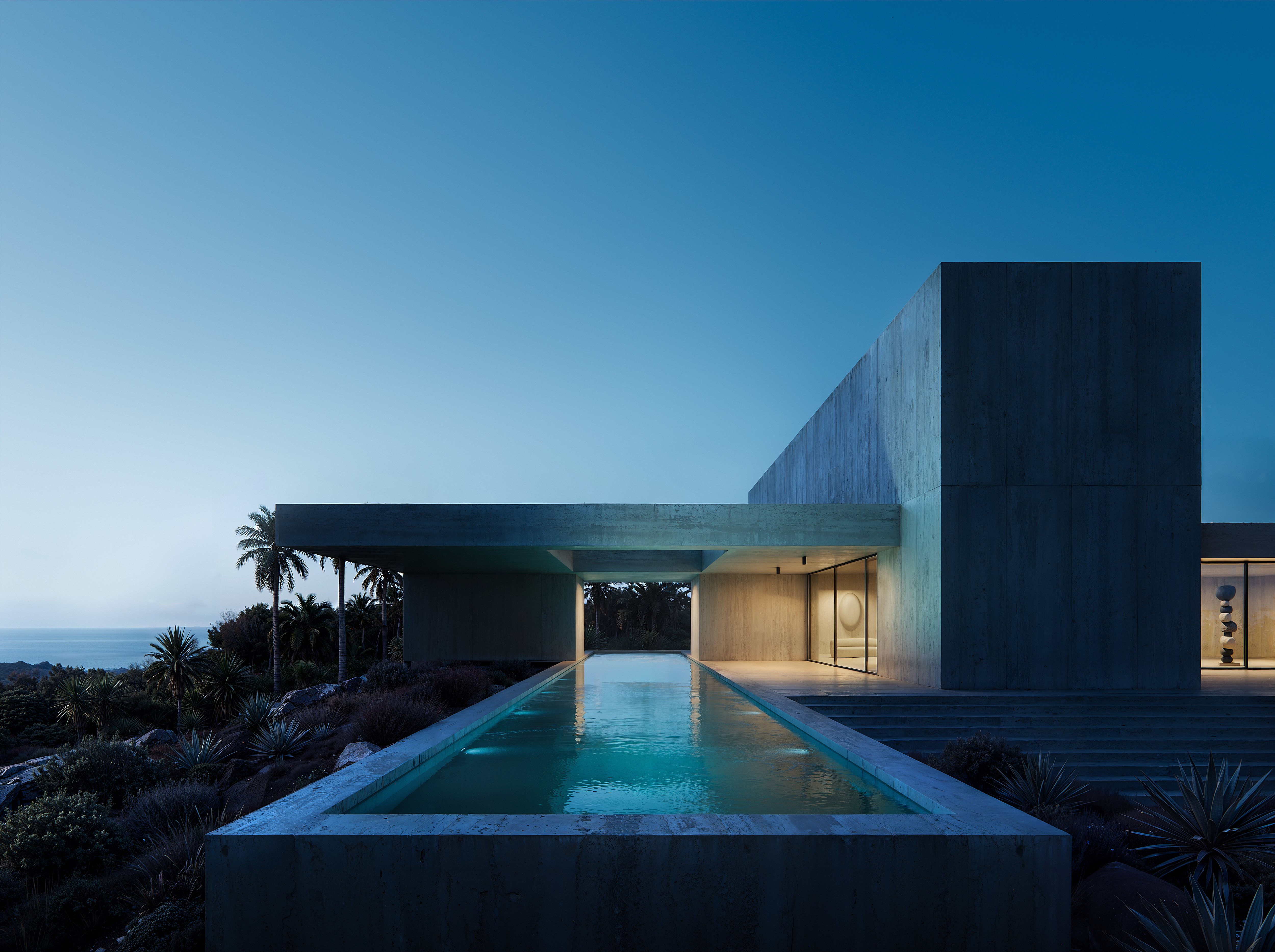 Beachfront estate with reflective pools and cantilevered concrete forms