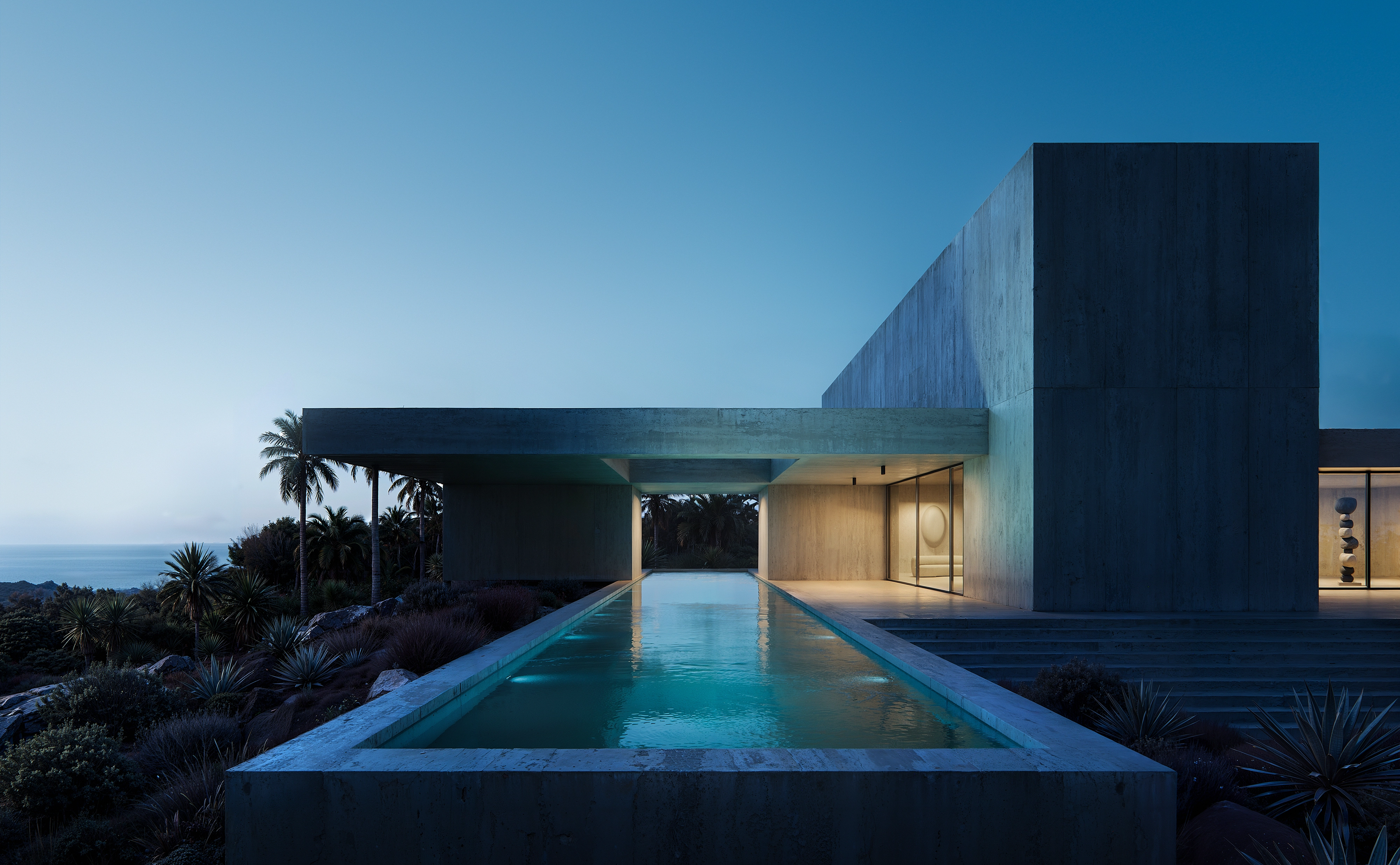 Beachfront estate with reflective pools and cantilevered concrete forms