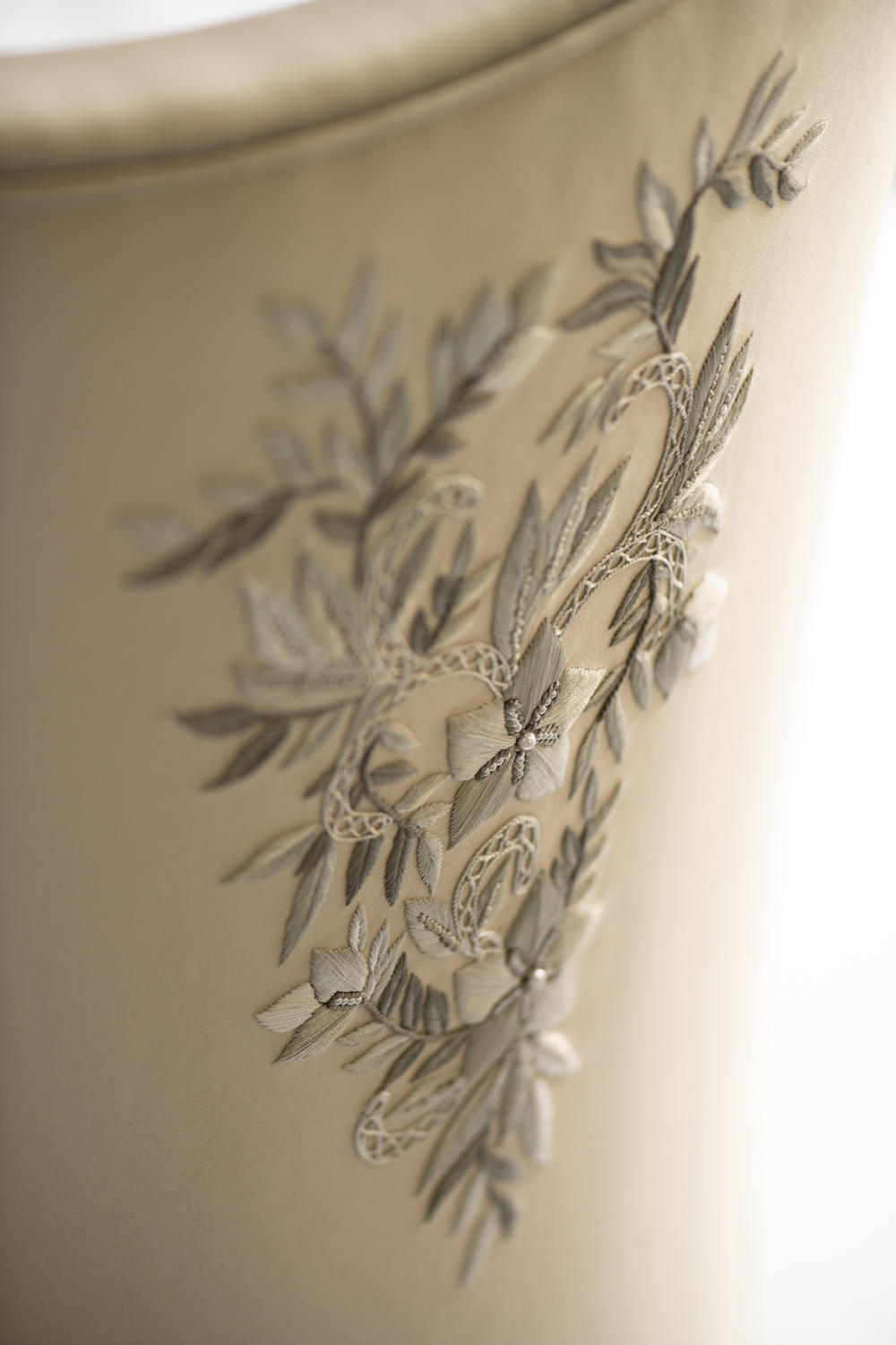 Hand-sculpted plaster relief of olive branches curving across a Mayfair, London wall