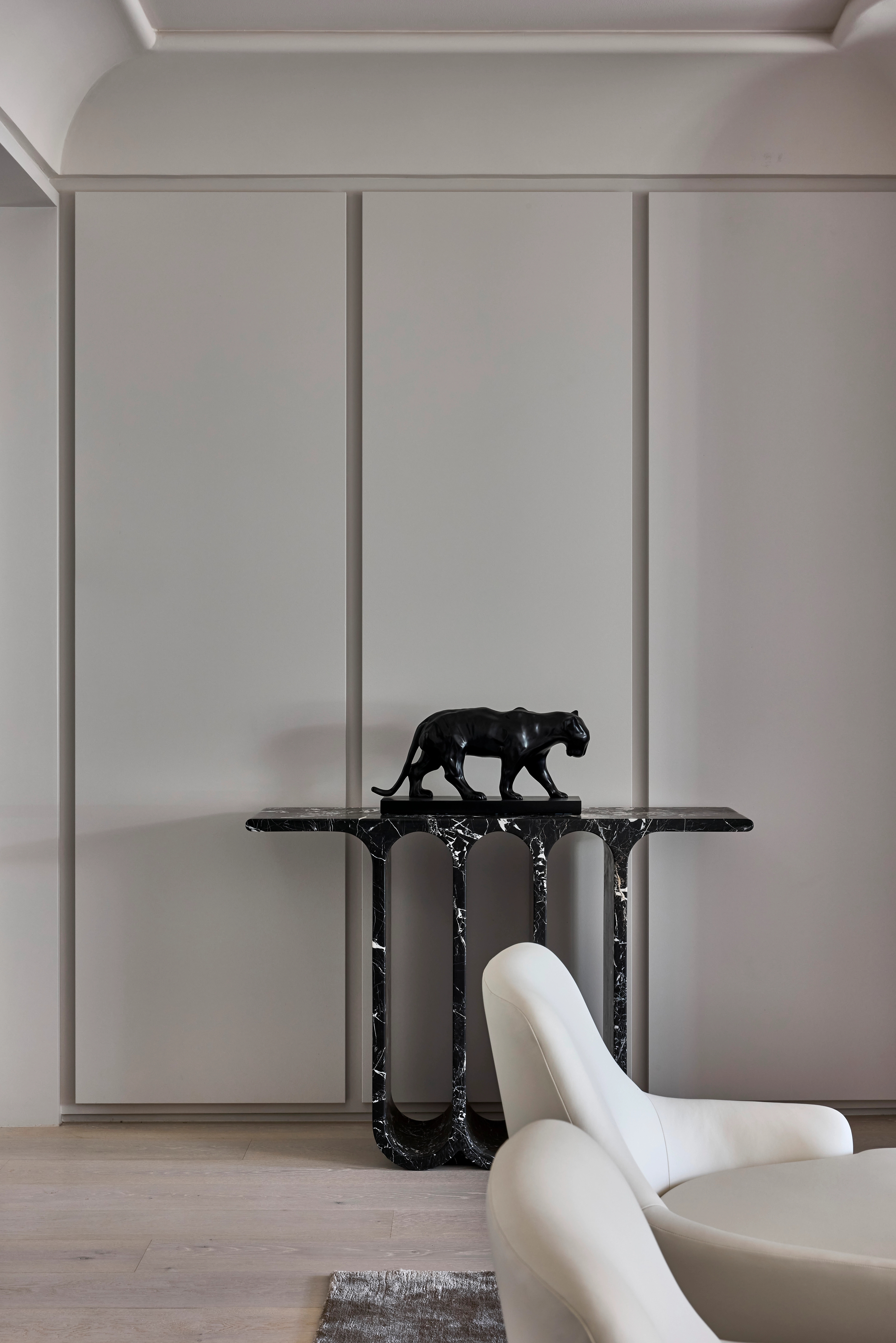 Panelled room, Jack Freeman-designed, pairing a black velvet wingback with marble surrounds and a bust
