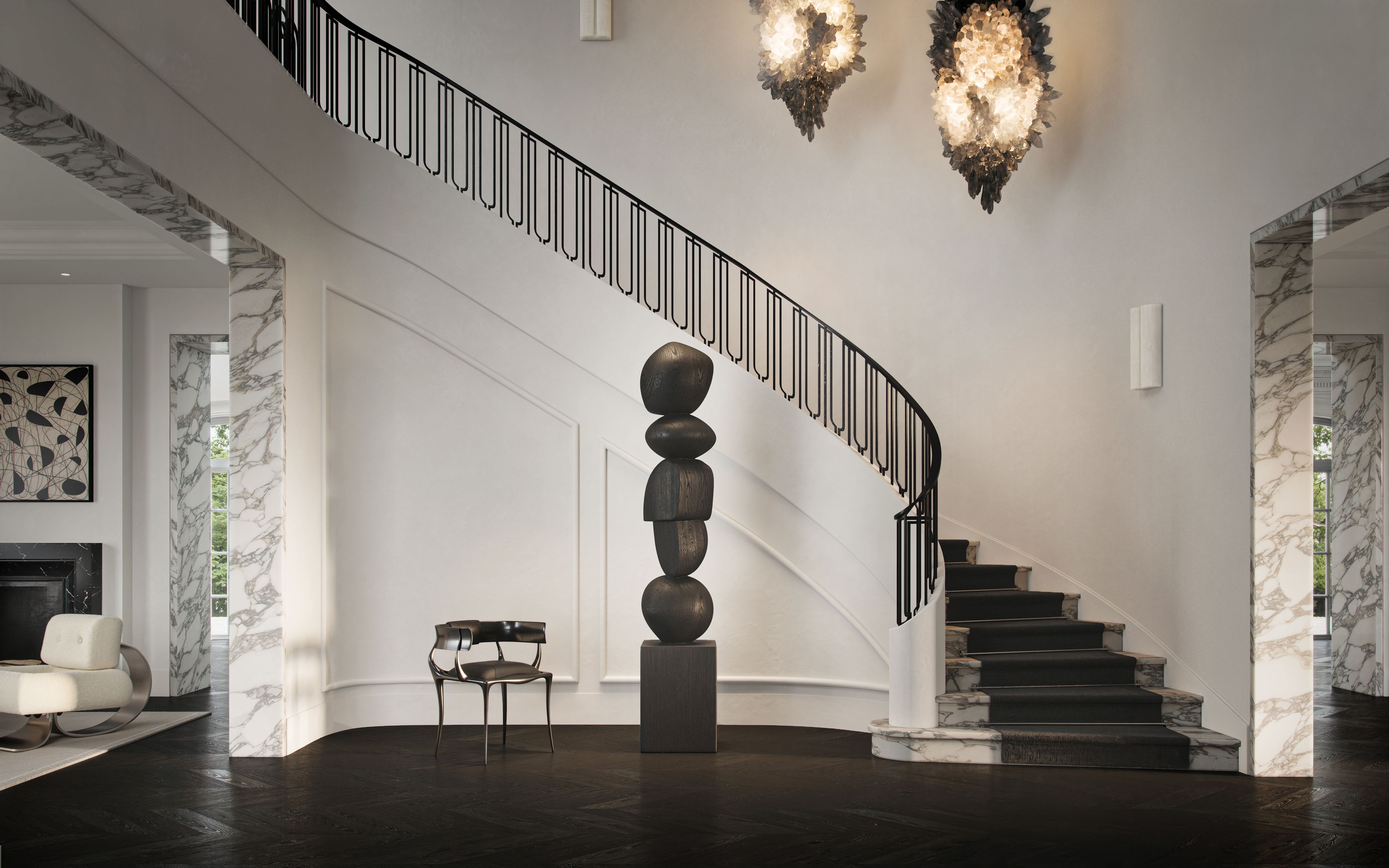 Palm Beach foyer by Freeman & Co with a sweeping staircase, stacked-stone totem and twin lanterns