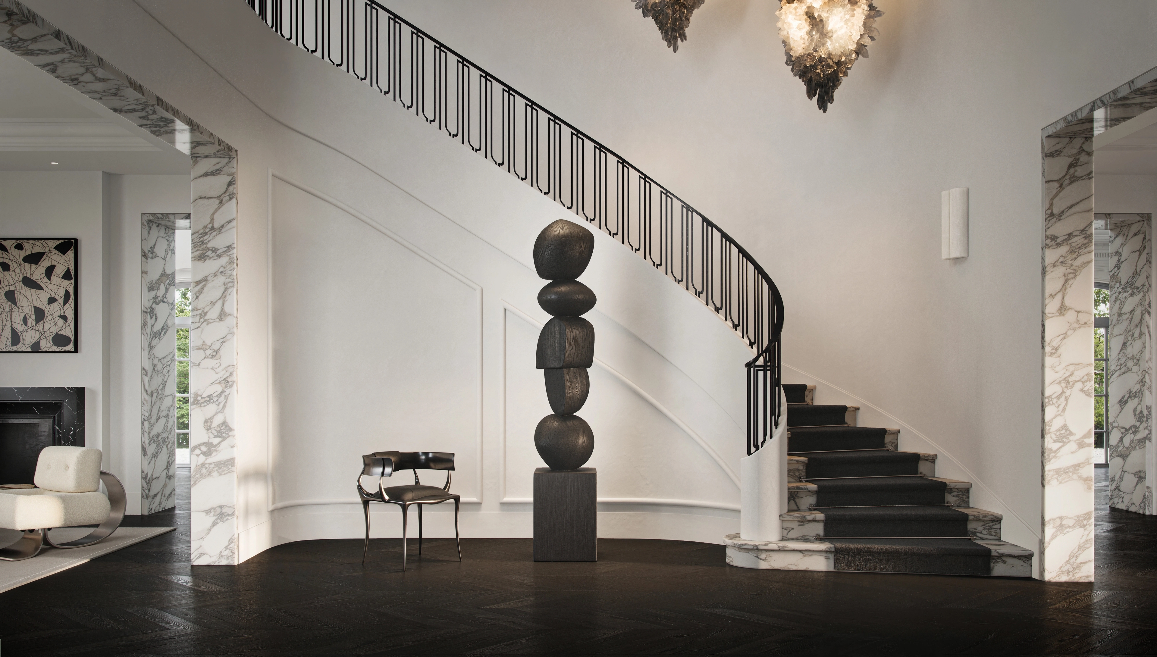 Palm Beach foyer by Freeman & Co with a sweeping staircase, stacked-stone totem and twin lanterns