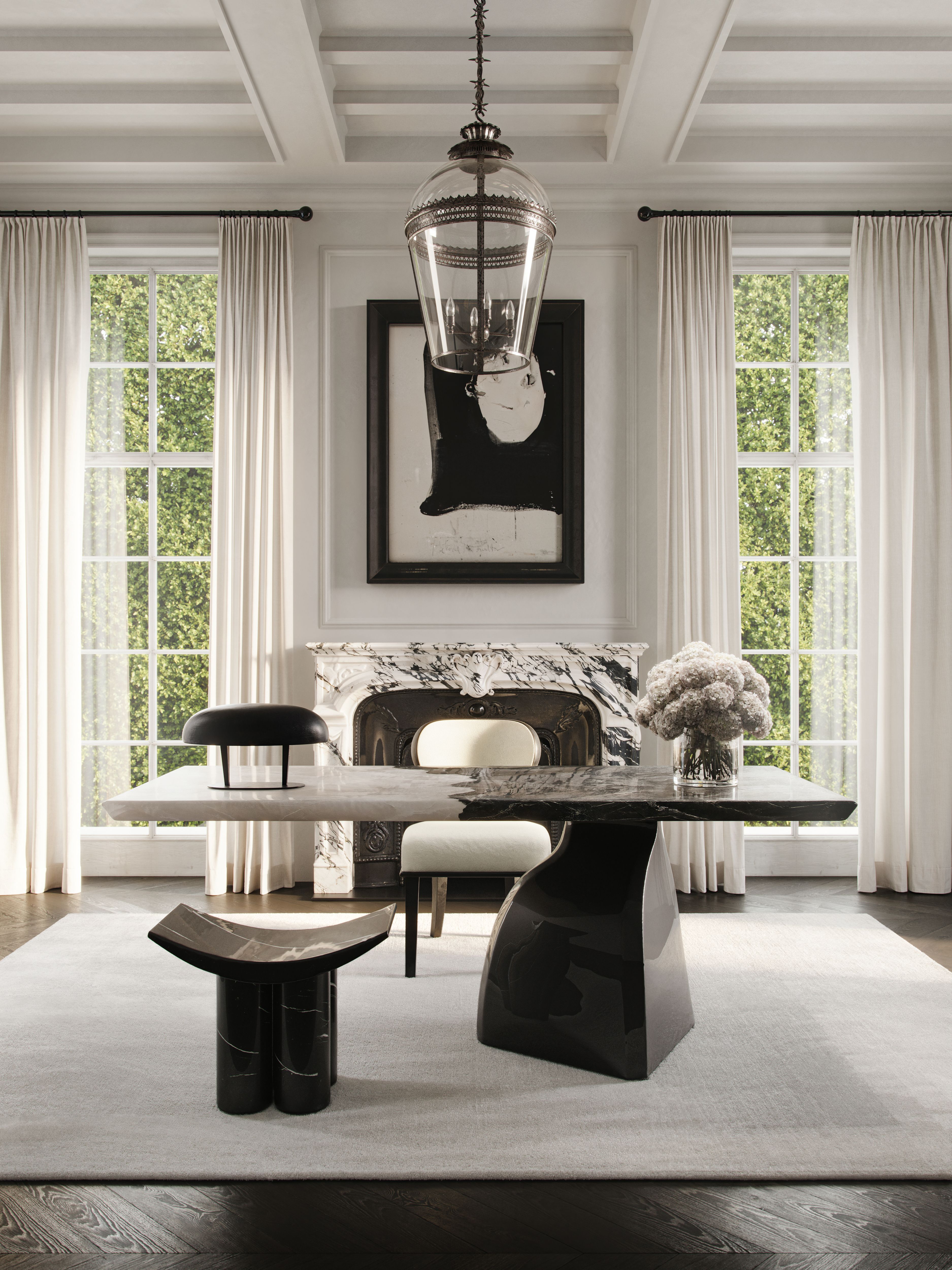 Sculptural stone dining table paired with blackened chairs beneath a lantern pendant, Palm Beach