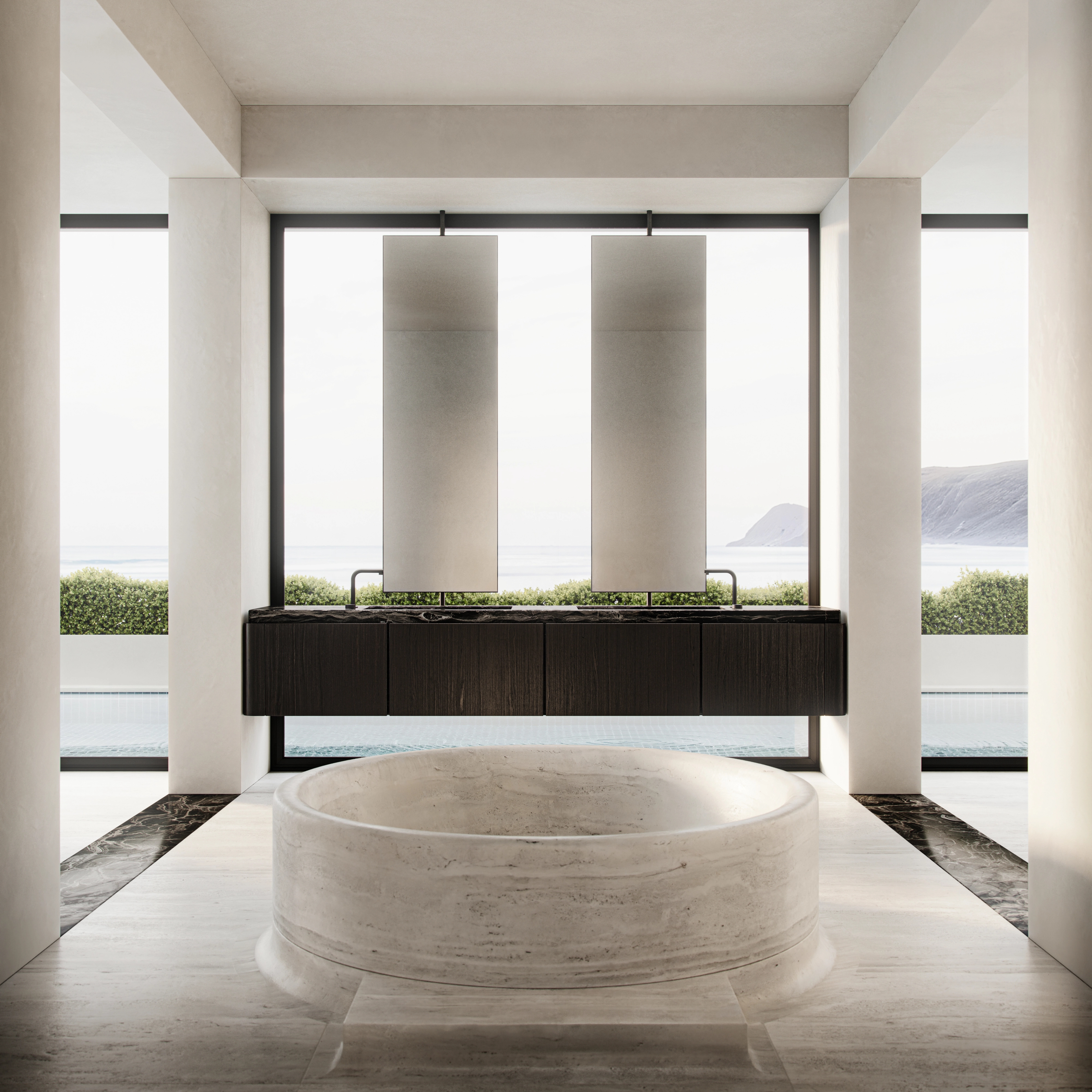 Round stone bath framed by floor-to-ceiling ocean views on the South Coast