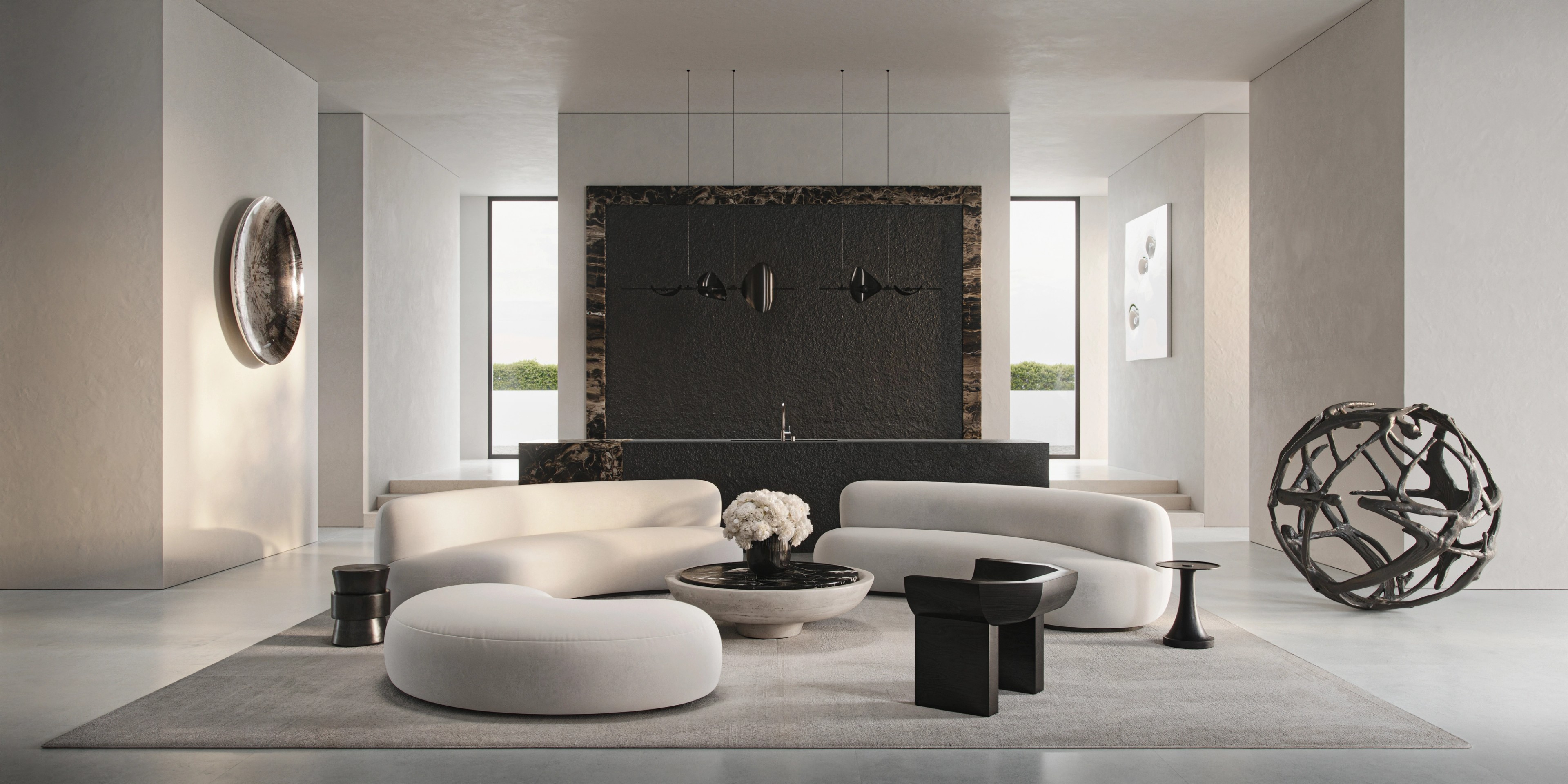 Principal living space with a monumental stone wall and sculptural lounge by Pierre Augustin Rose