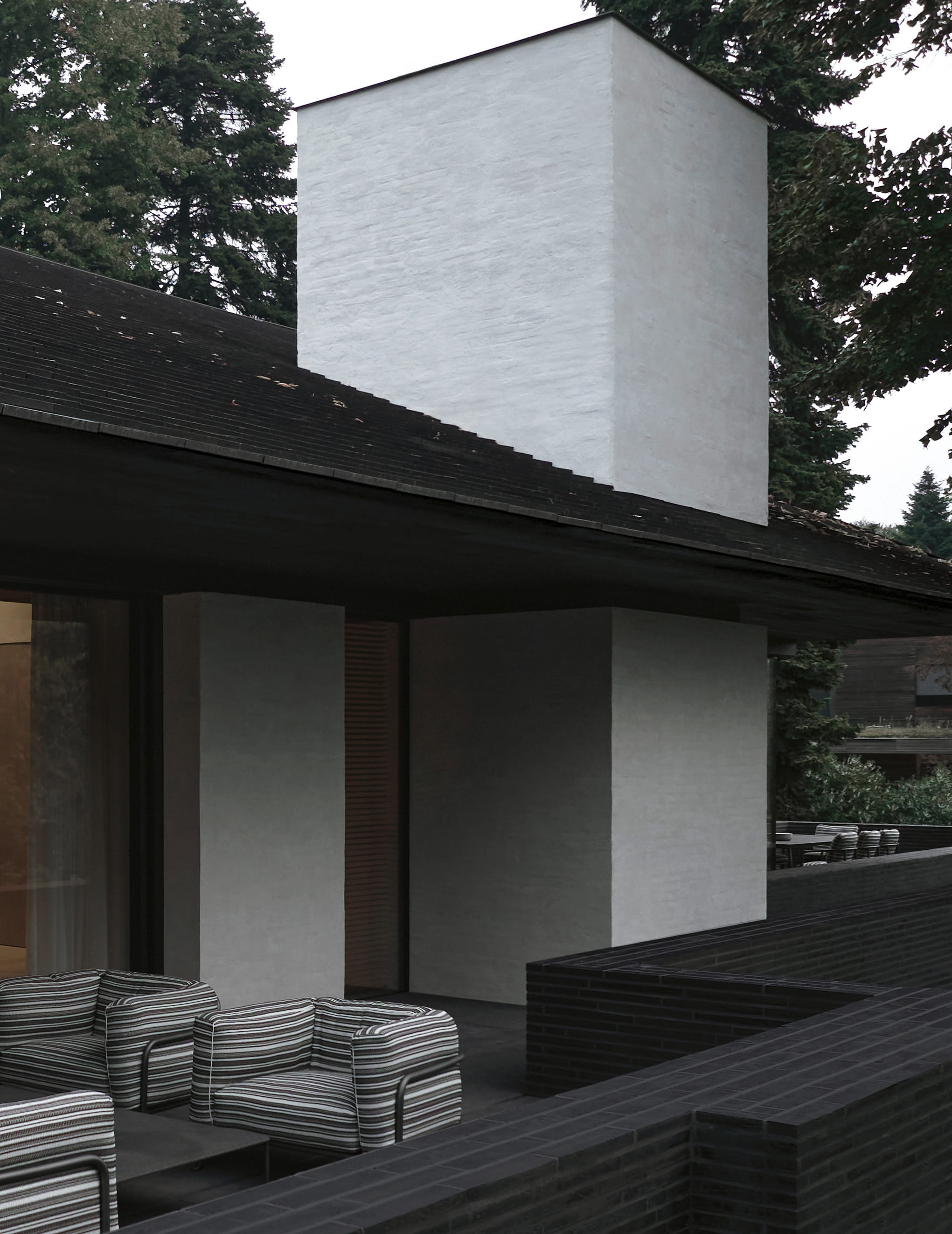 Minimalist rendered-and-brick house with a shaded terrace, designed by Vincent Van Duysen