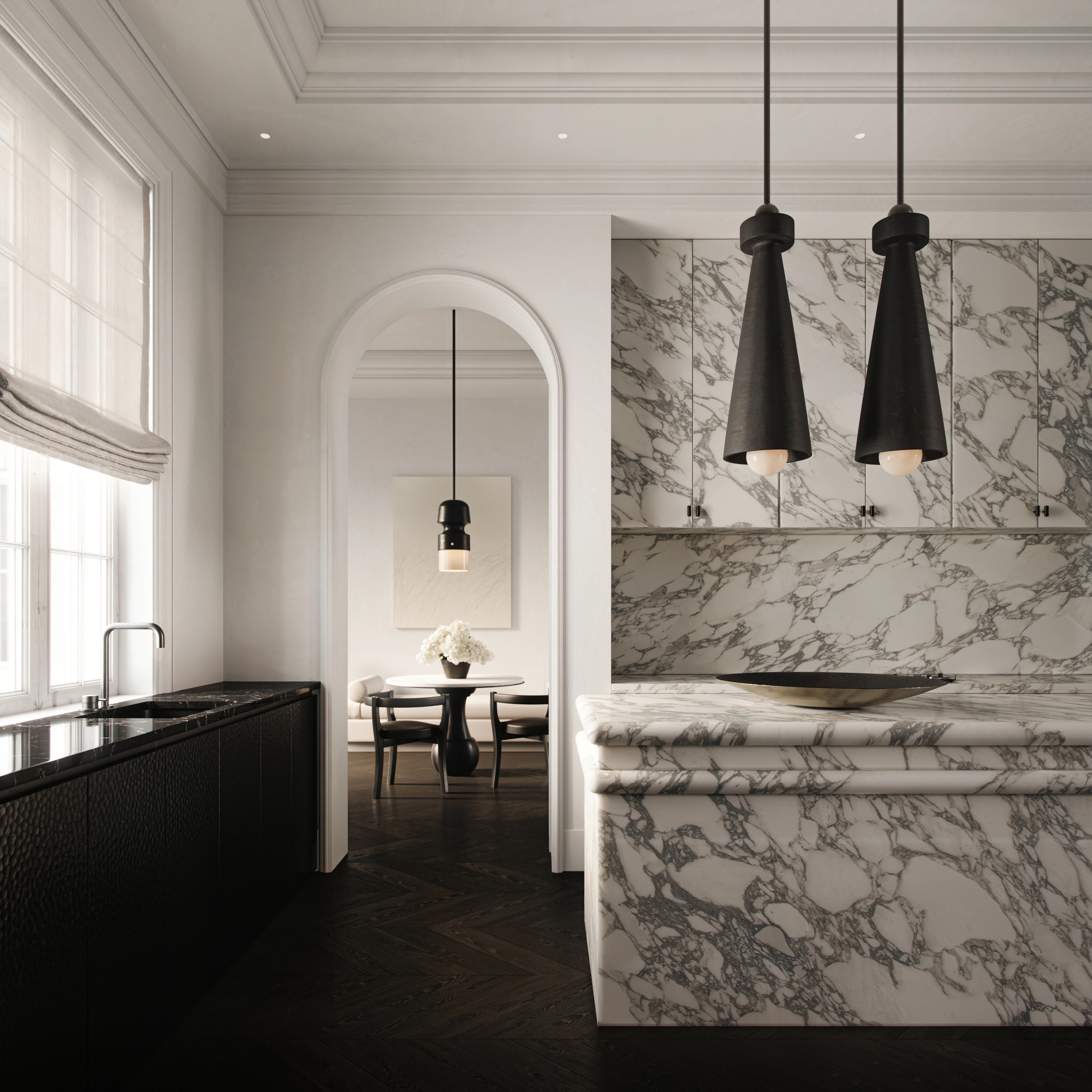 Bookmatched marble kitchen with black pendant lights and a softly arched alcove