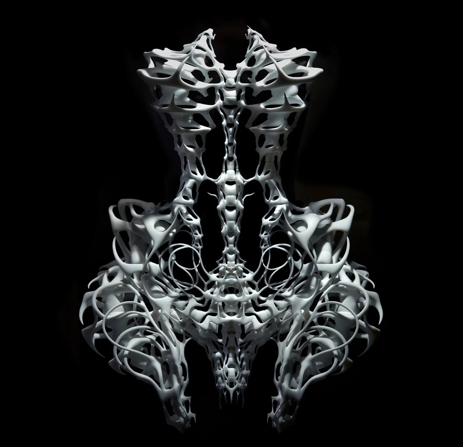 Intricate skeletal filigree form suspended against black, echoing Iris van Herpen's craft