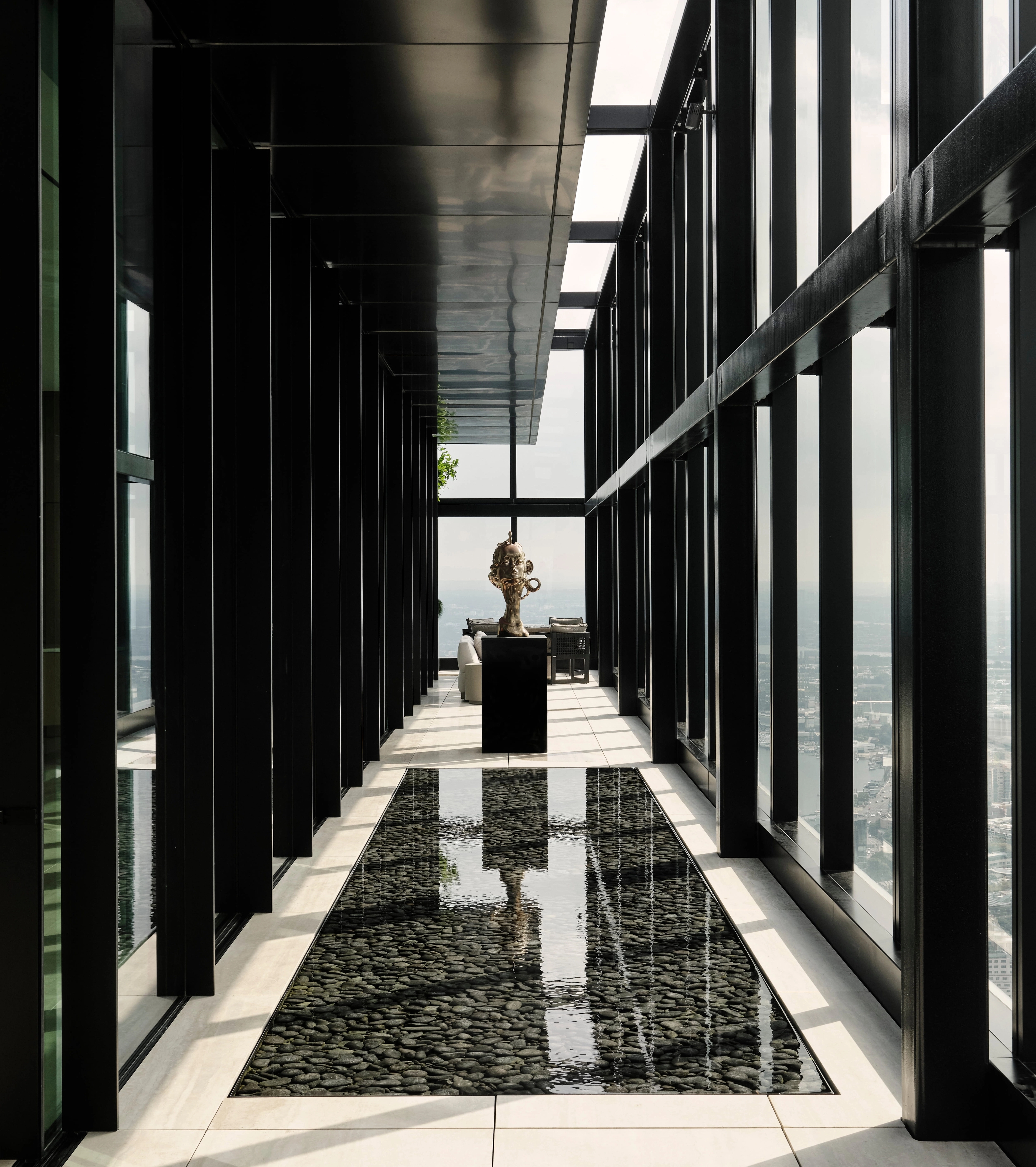 Mirror-clad corridor reflecting a lone plinth-mounted sculpture toward the light, Sydney CBD