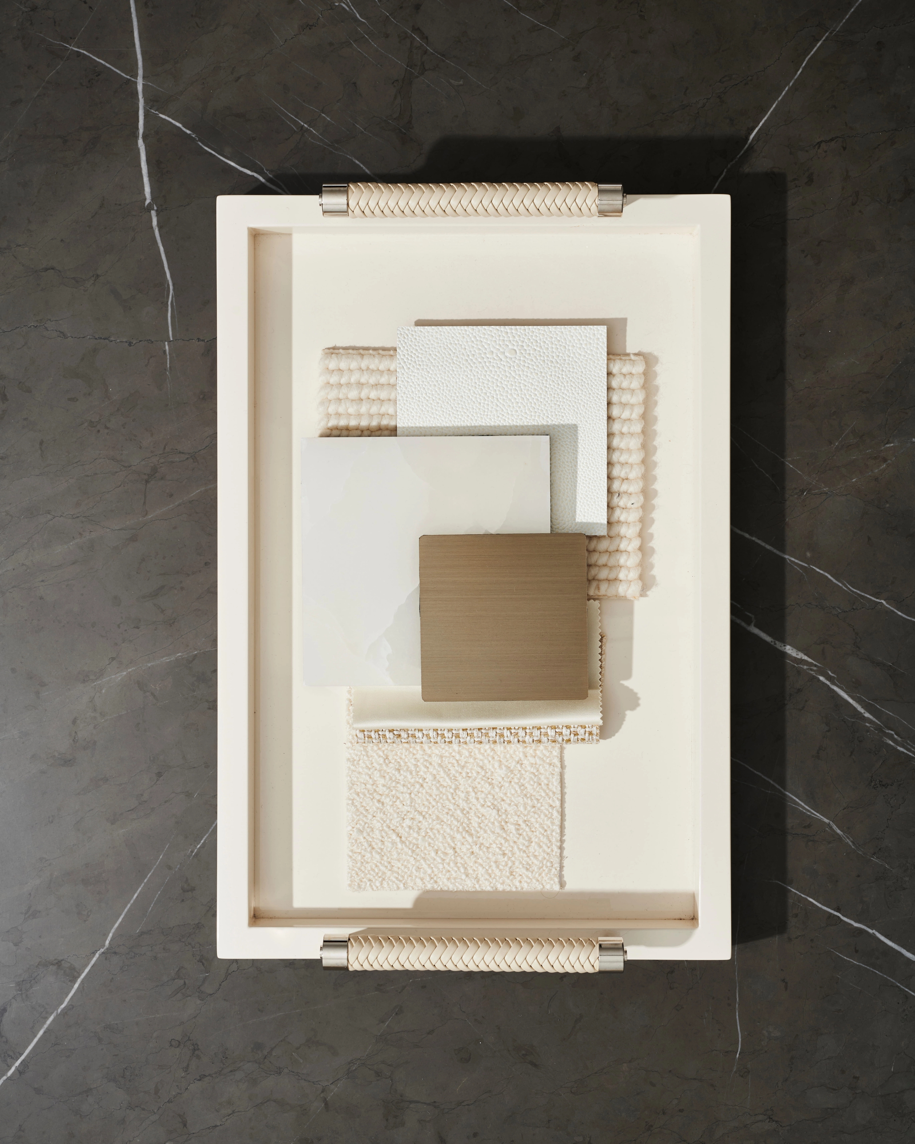 Textured architectural maquette and cream relief studied on black marble
