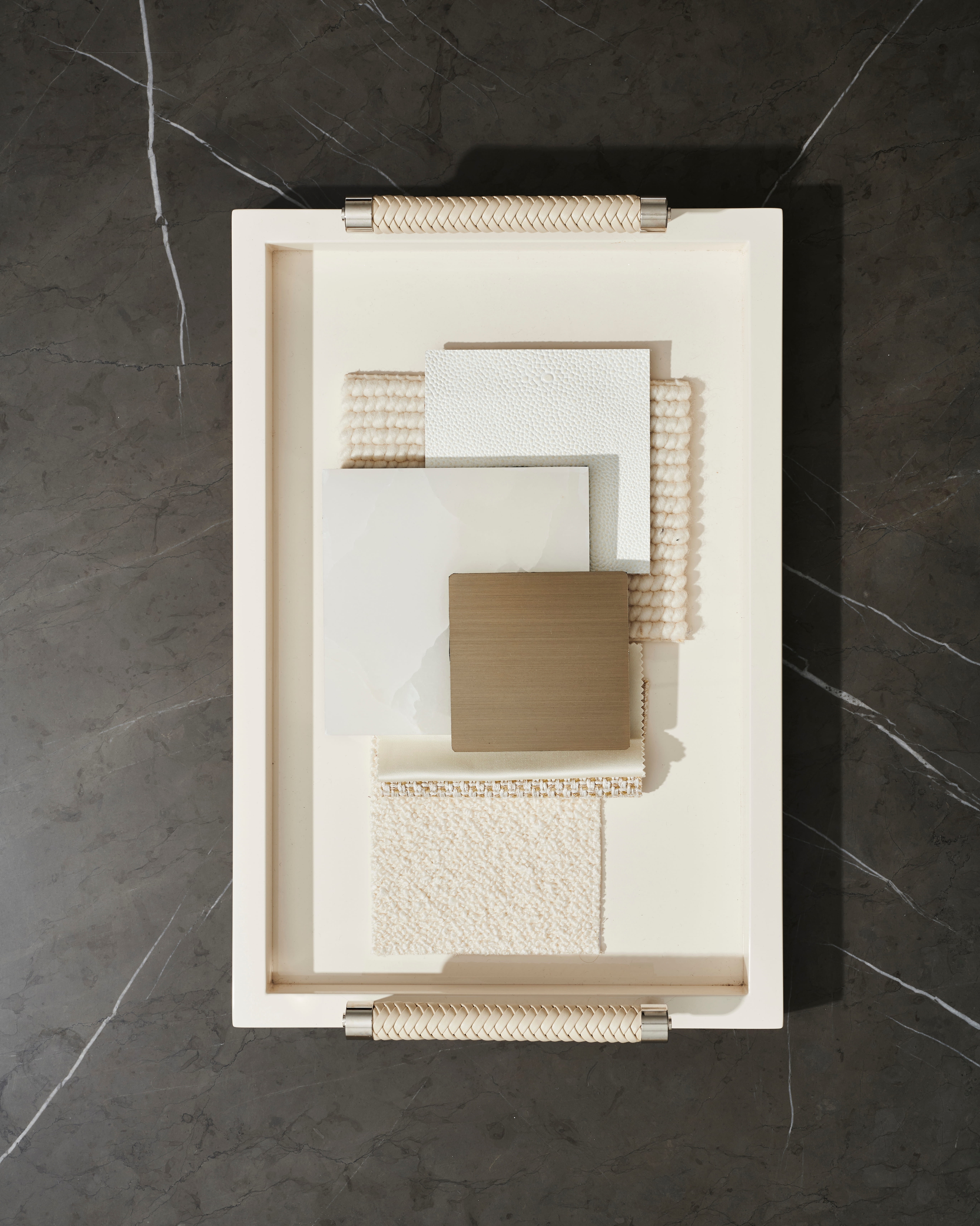Textured architectural maquette and cream relief studied on black marble
