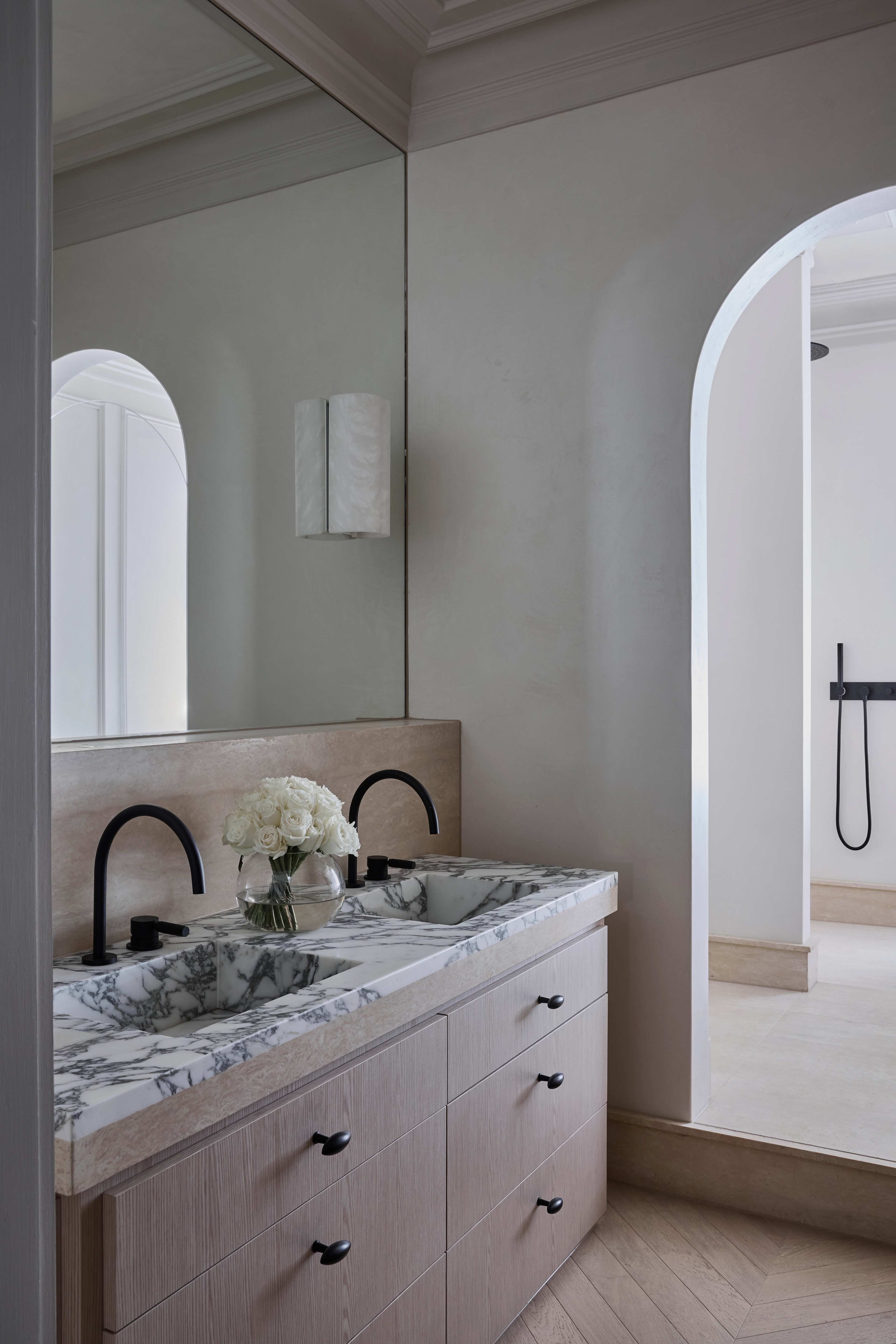 Marble double vanity with black tapware and an arched opening to the shower, Paddington