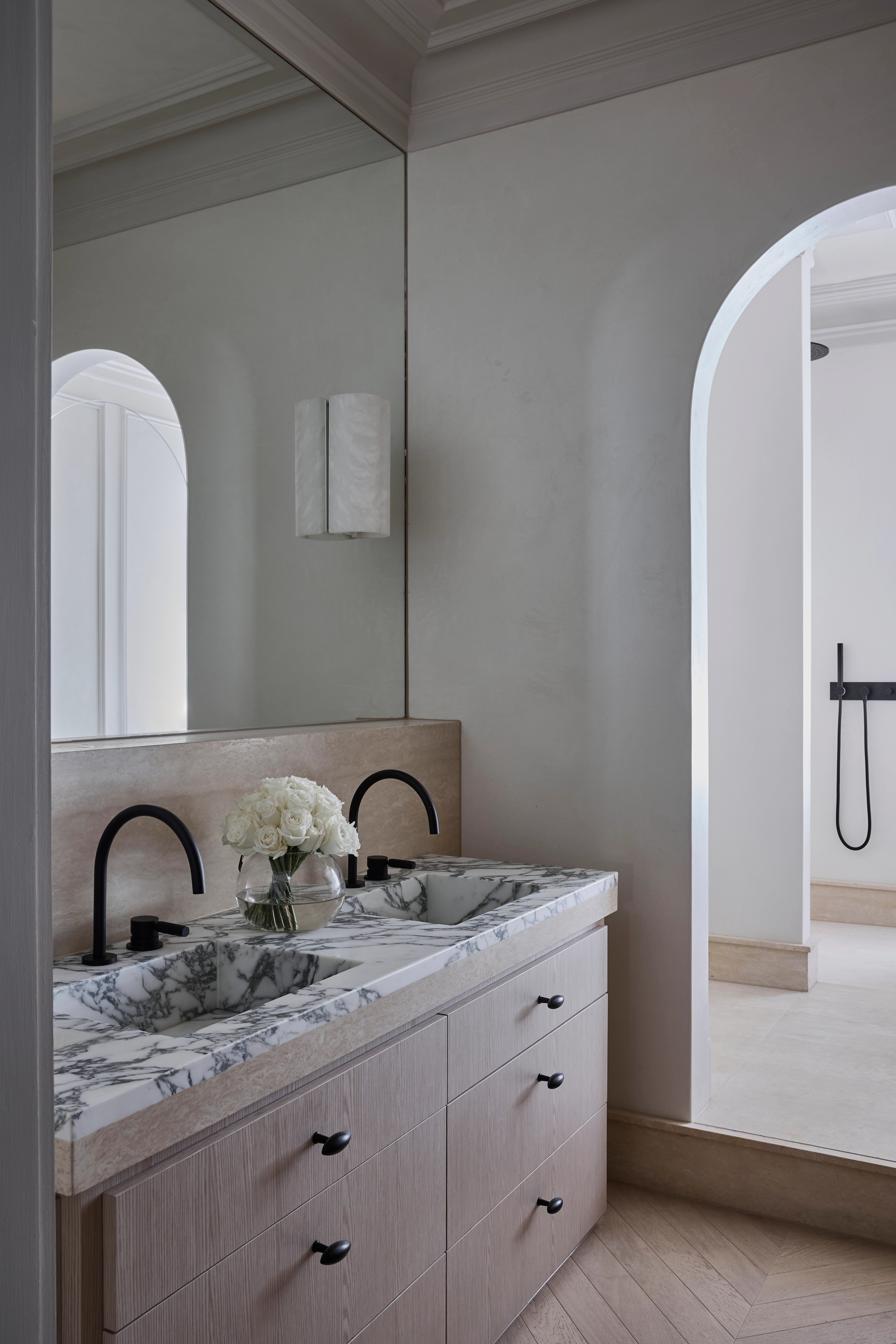 Marble double vanity with black tapware and an arched opening to the shower, Paddington