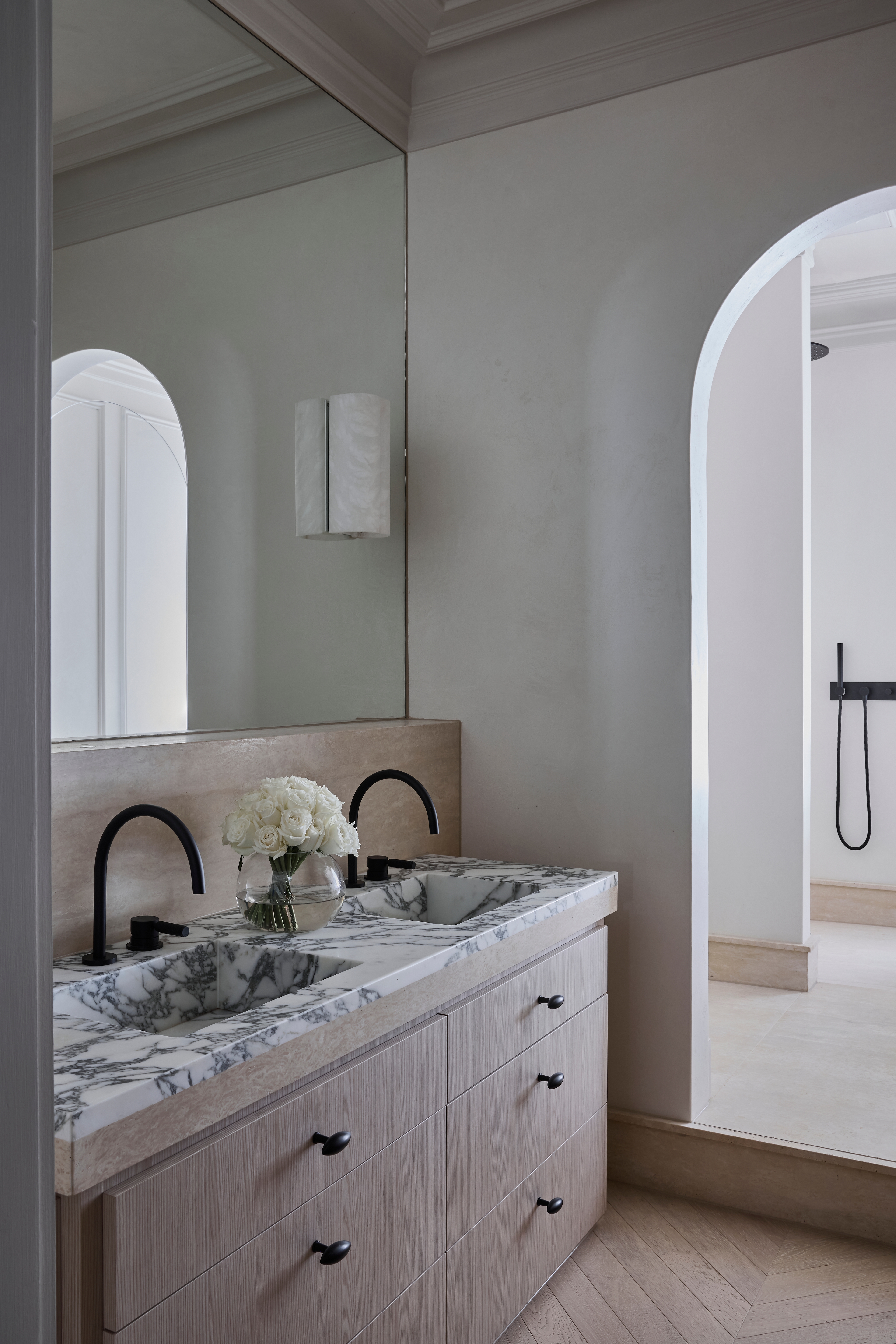 Marble double vanity with black tapware and an arched opening to the shower, Paddington