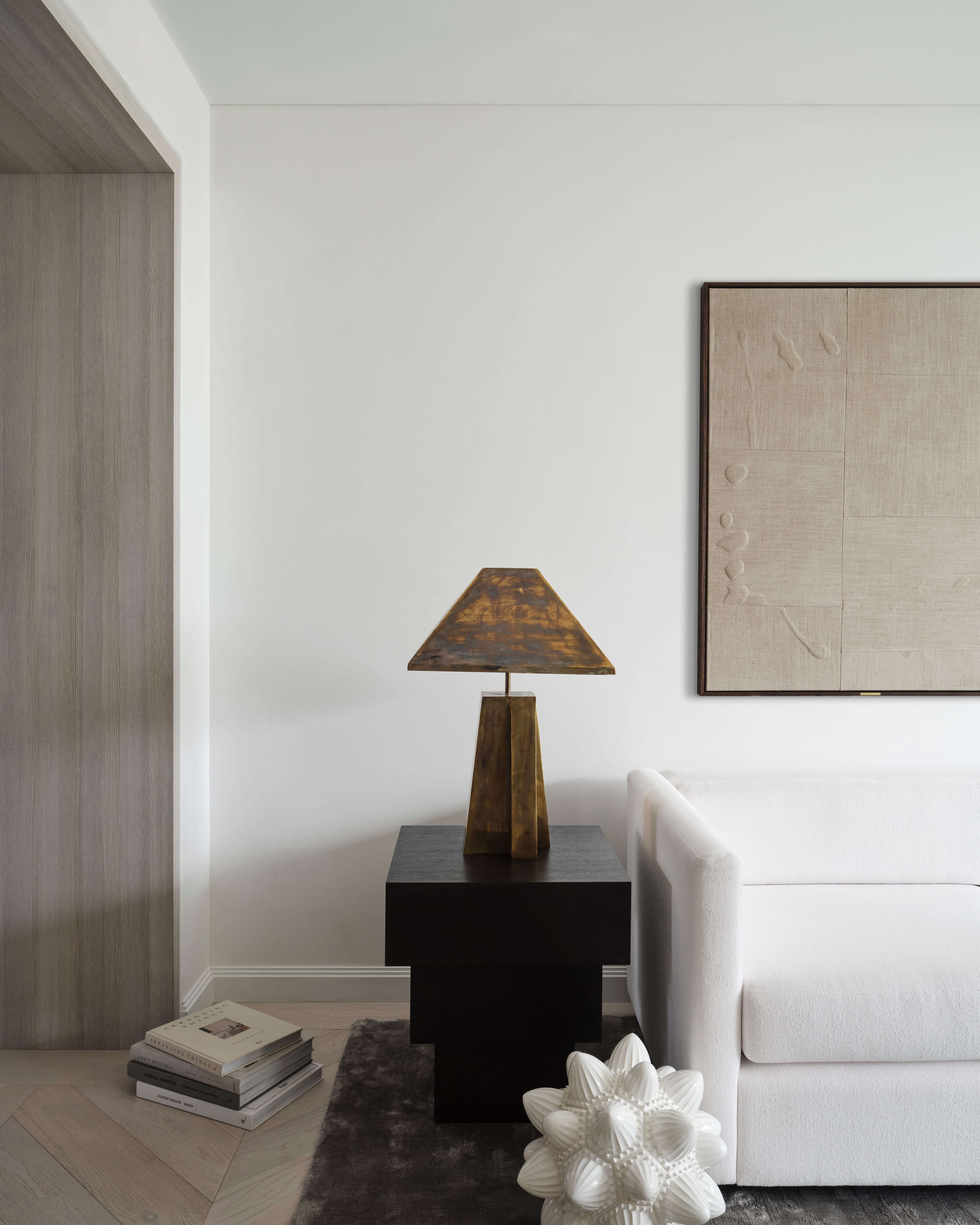 Quiet reading corner with bronze lamp and textured artwork in Elizabeth Bay