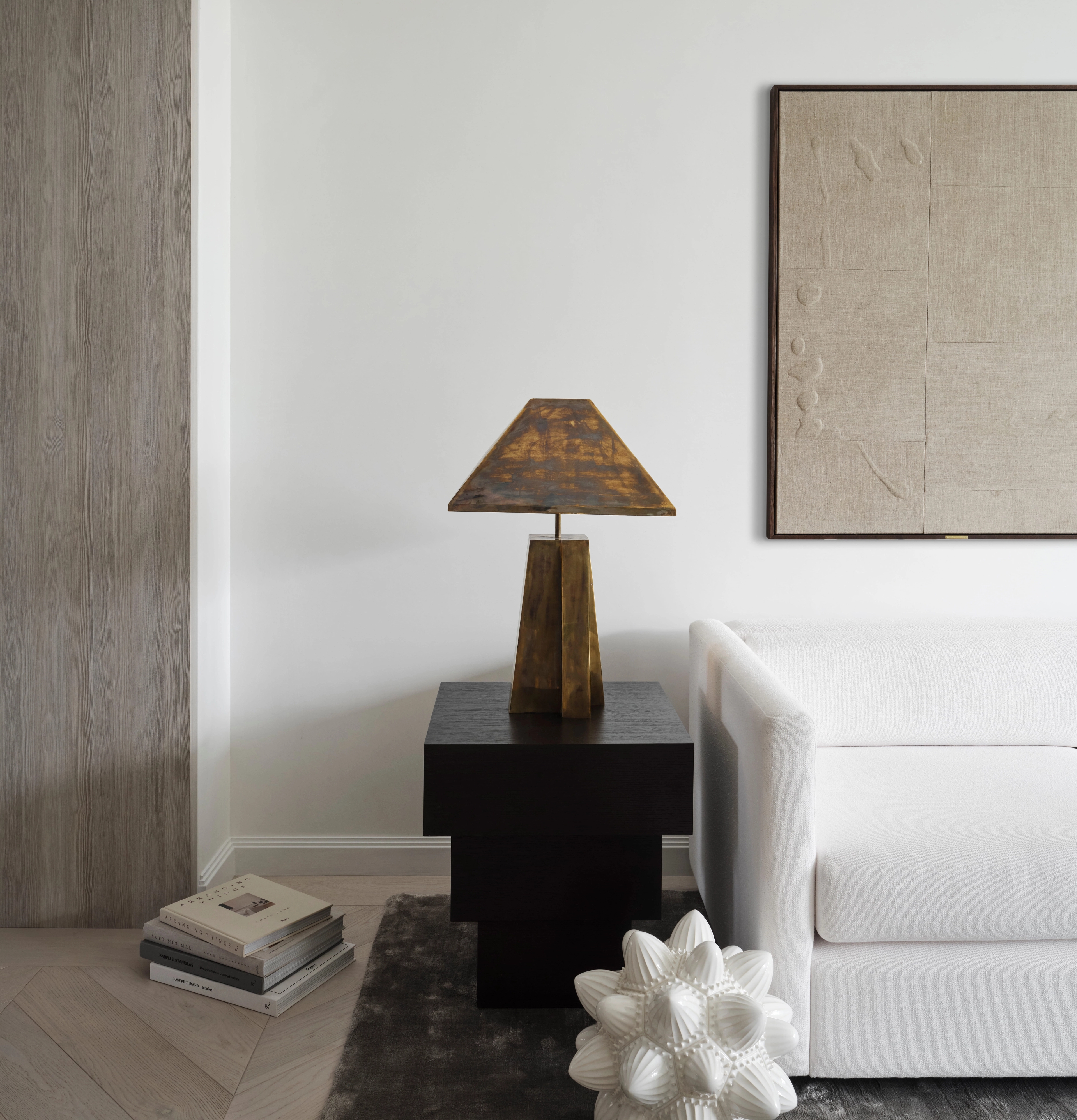 Quiet reading corner with bronze lamp and textured artwork in Elizabeth Bay