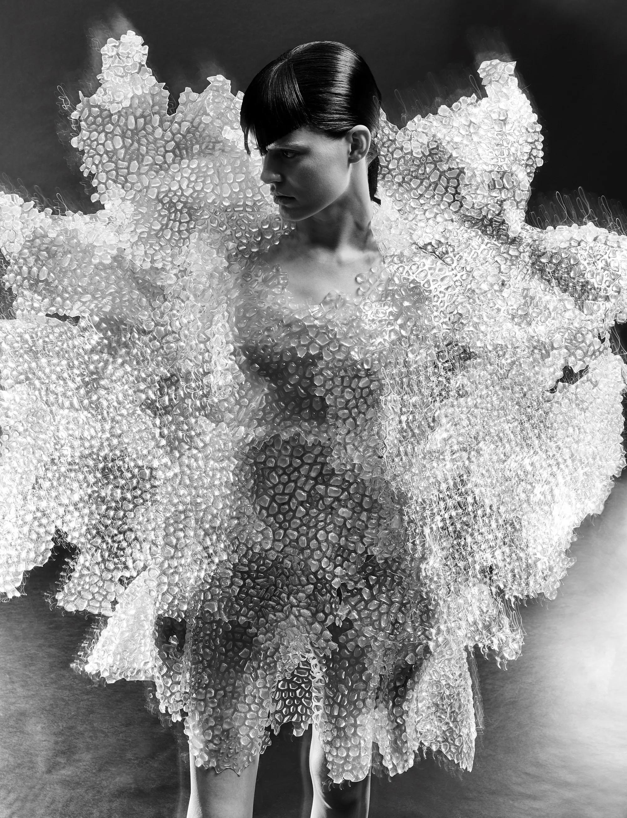 Model wearing an intricate coral-like couture gown by designer Iris van Herpen